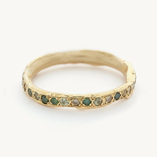 green sapphires and diamon eternity ring in yellow gold