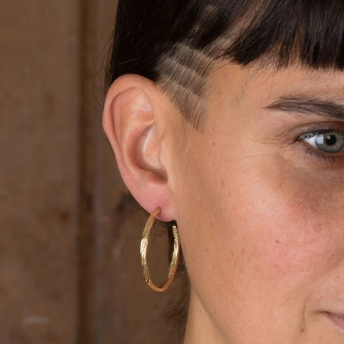 gold ripple hoop earrings worn