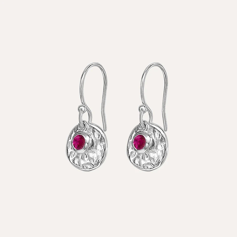 Silver earrings with ruby on a white background