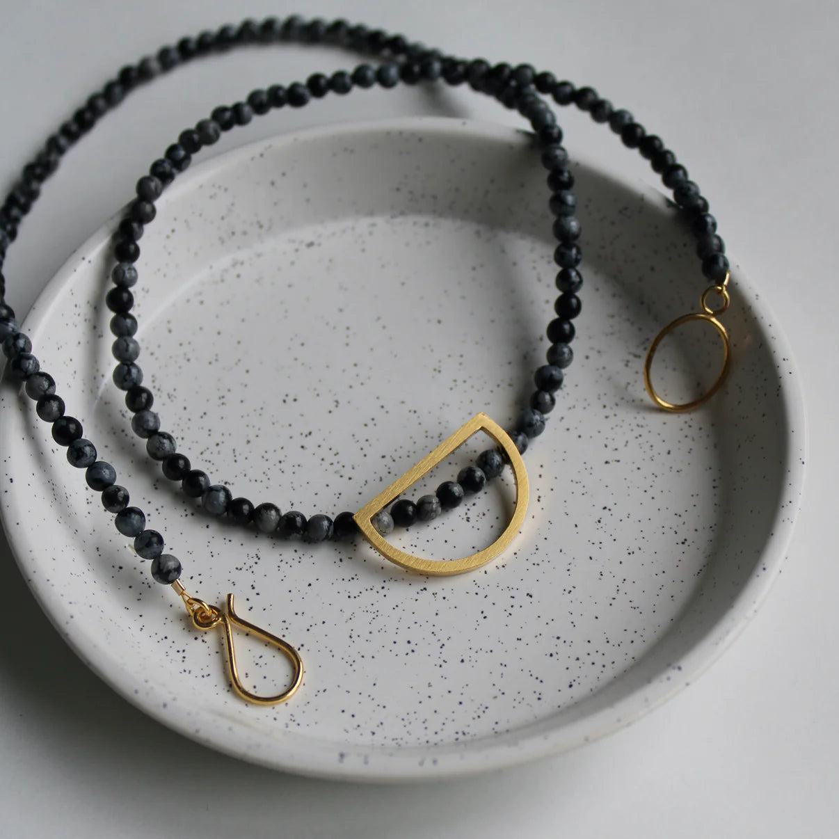 black bead necklace with gold detail