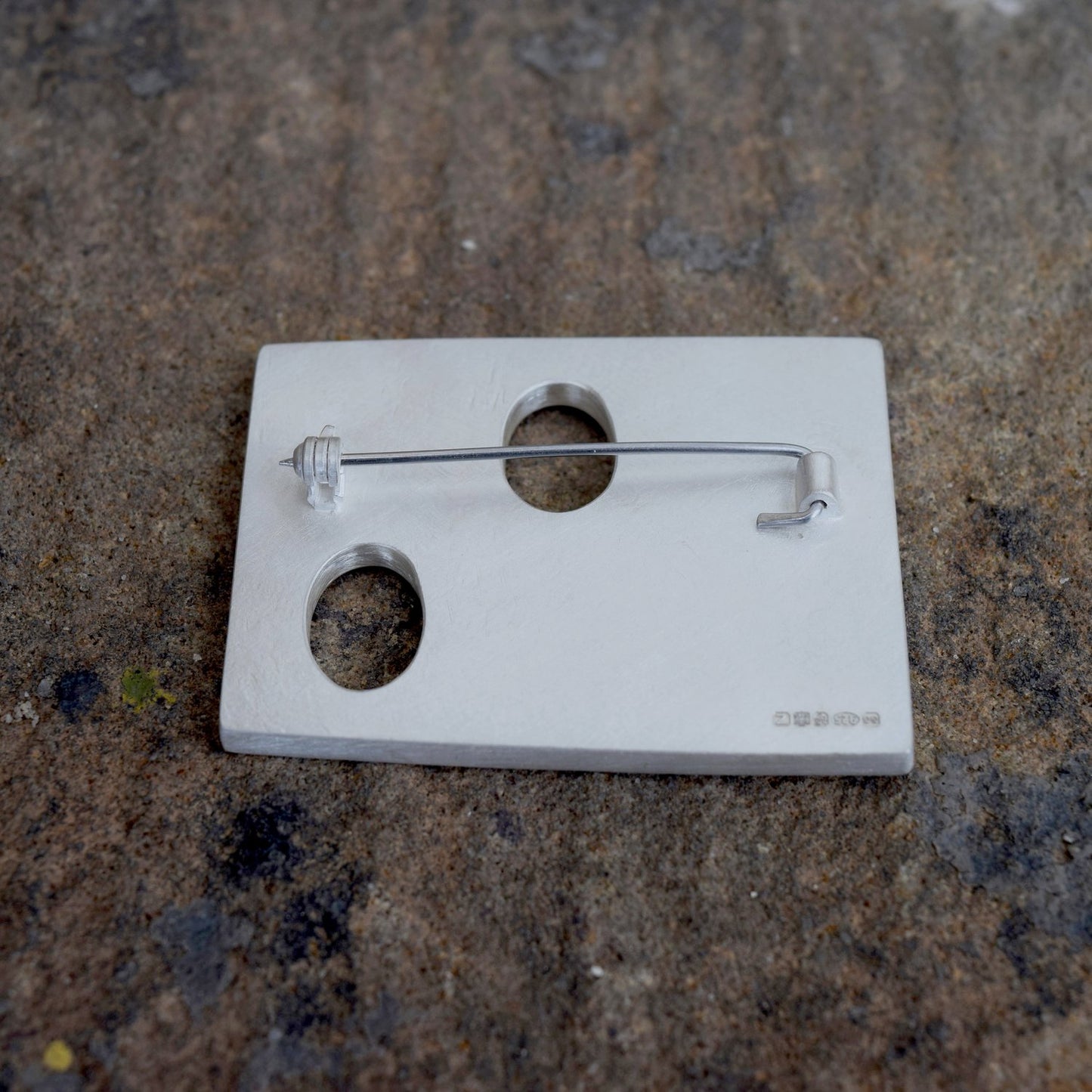 silver and pebble brooch