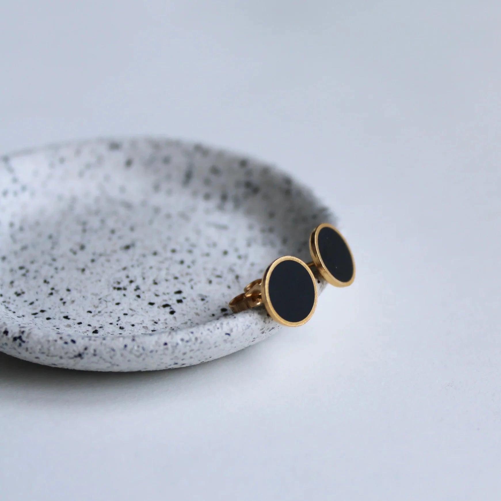 gold and black arc studs