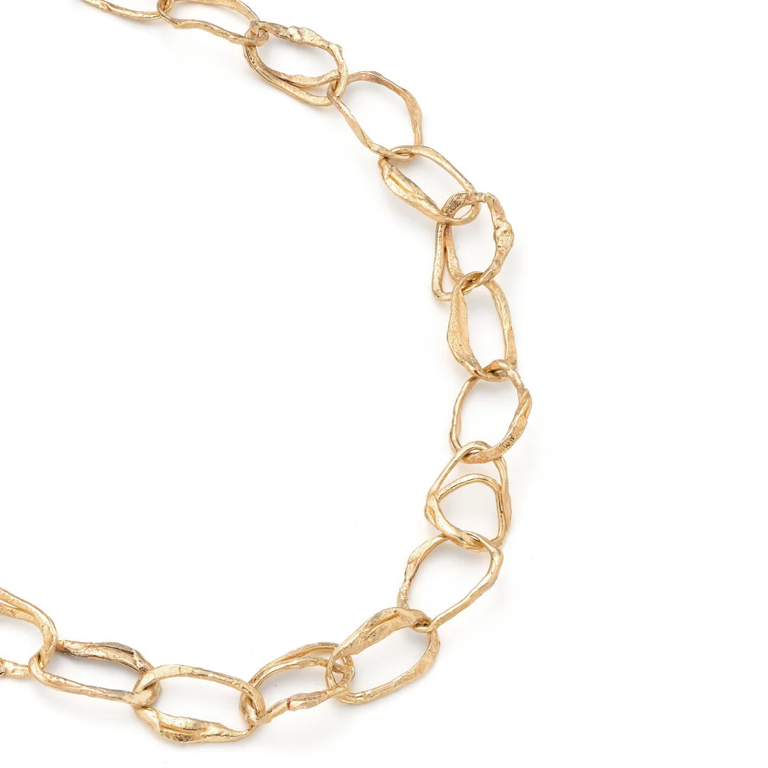 gold pebble drawing necklace close up