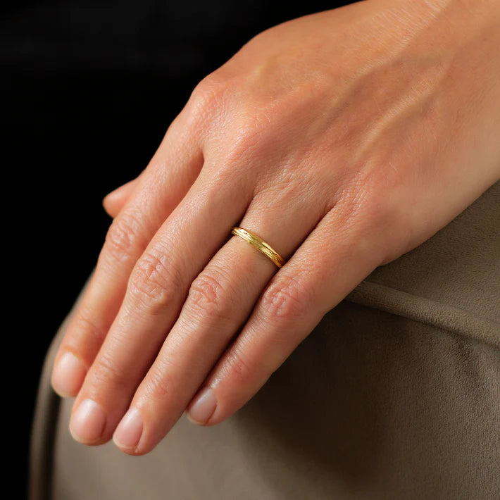 gold ripple ring worn
