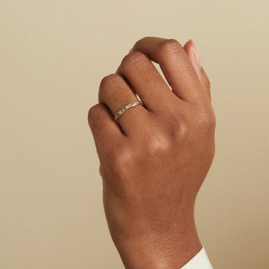 green sapphire and diamond eternity ring worn