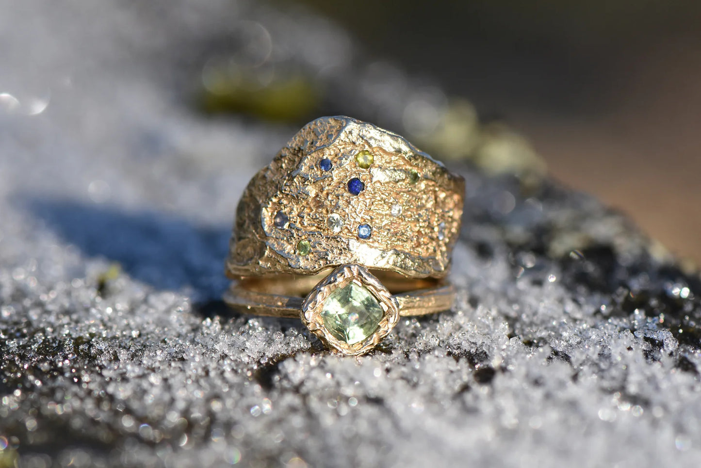 green sapphire ring stacked with another gold and sapphire ring