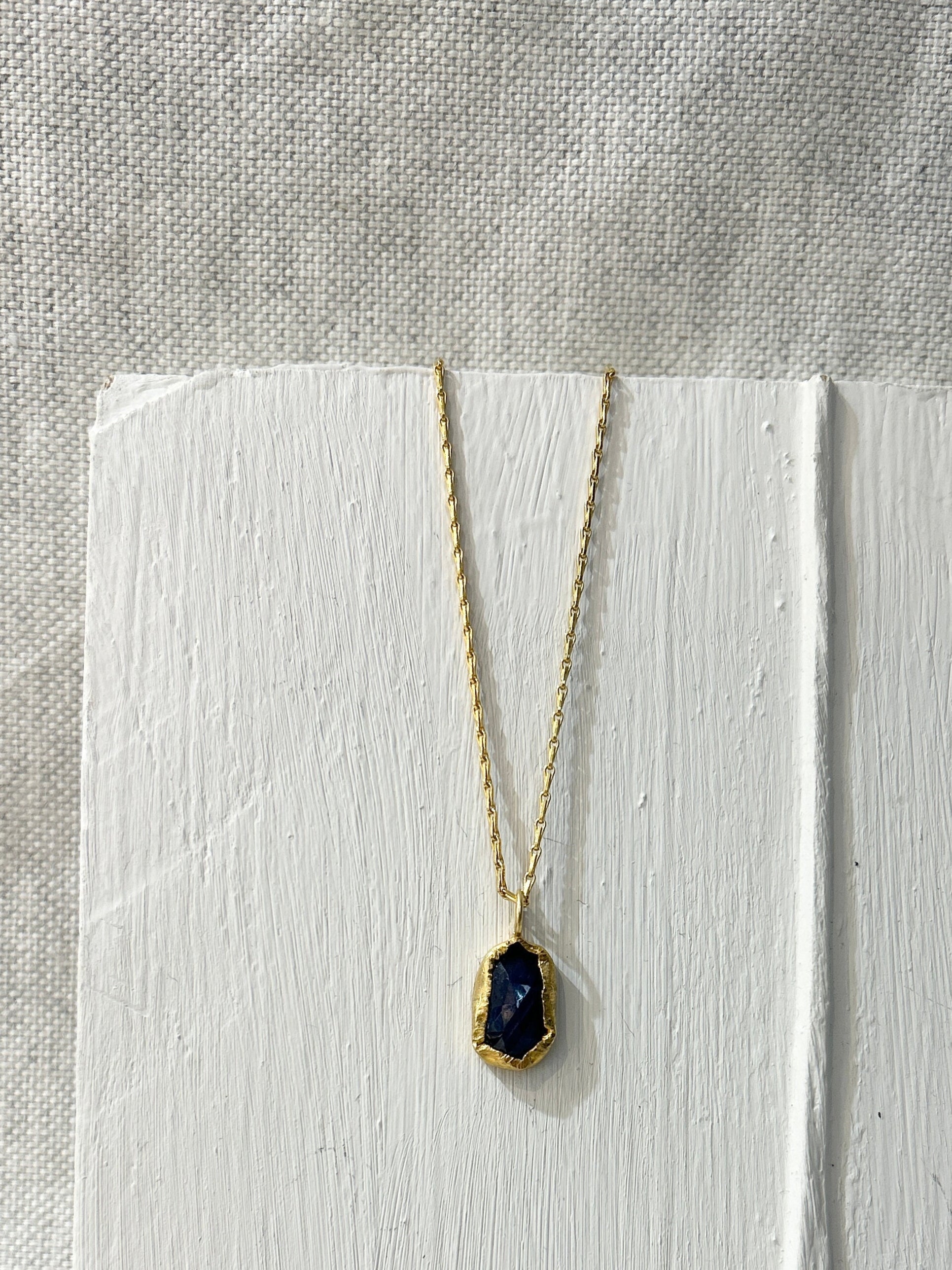 Necklace with a blue pendant on a white background