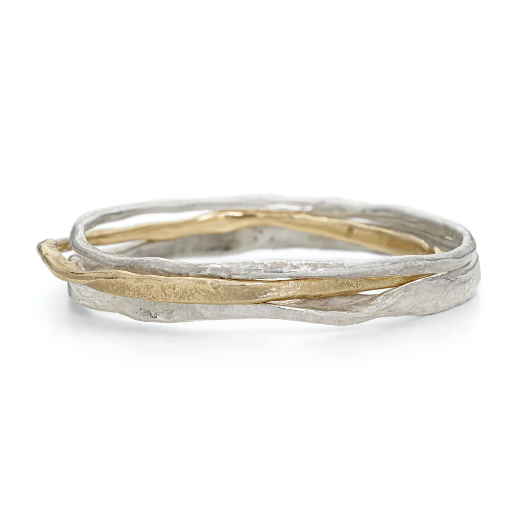 silver and gold bangle stack