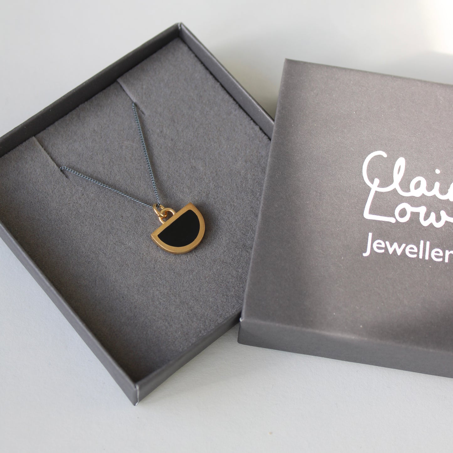 black resin and gold vermeil pendant on an oxidised silver necklace