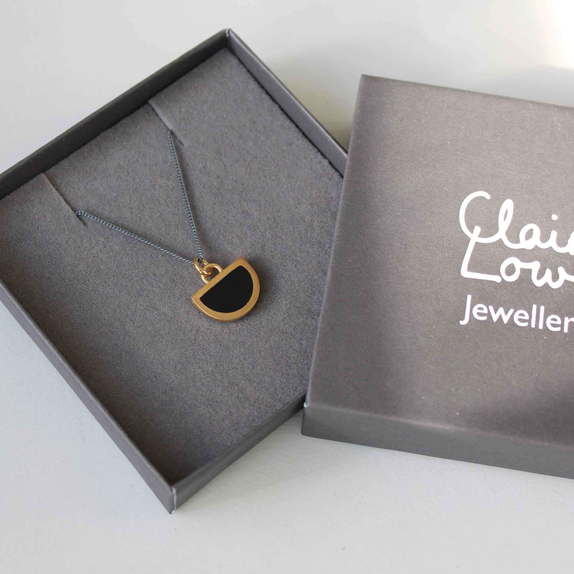 black resin and gold vermeil pendant on an oxidised silver necklace