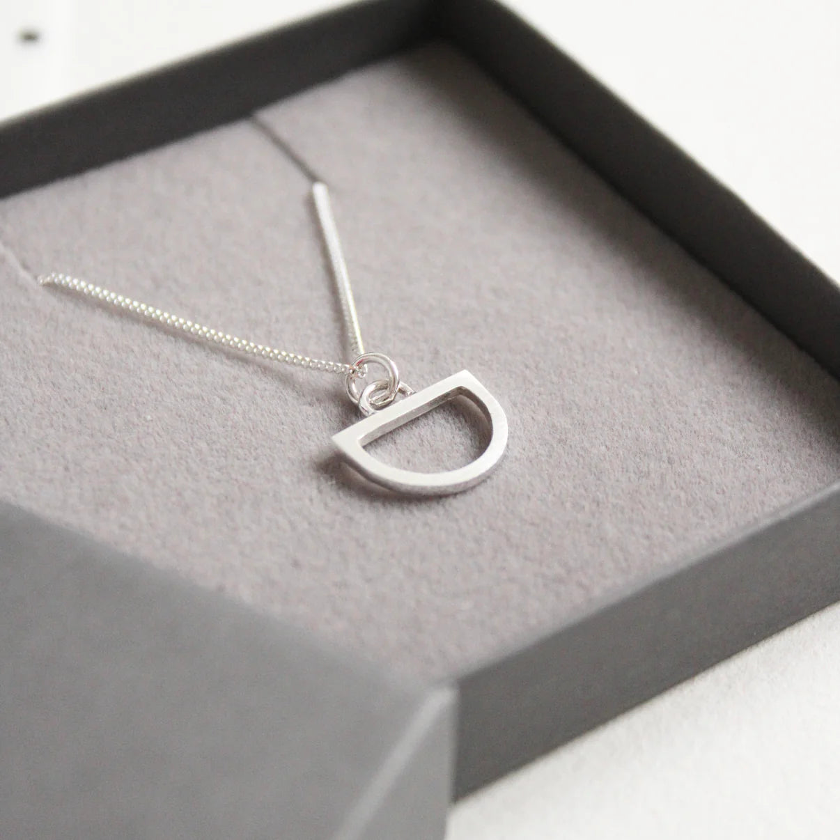 tiny silver arc pendant