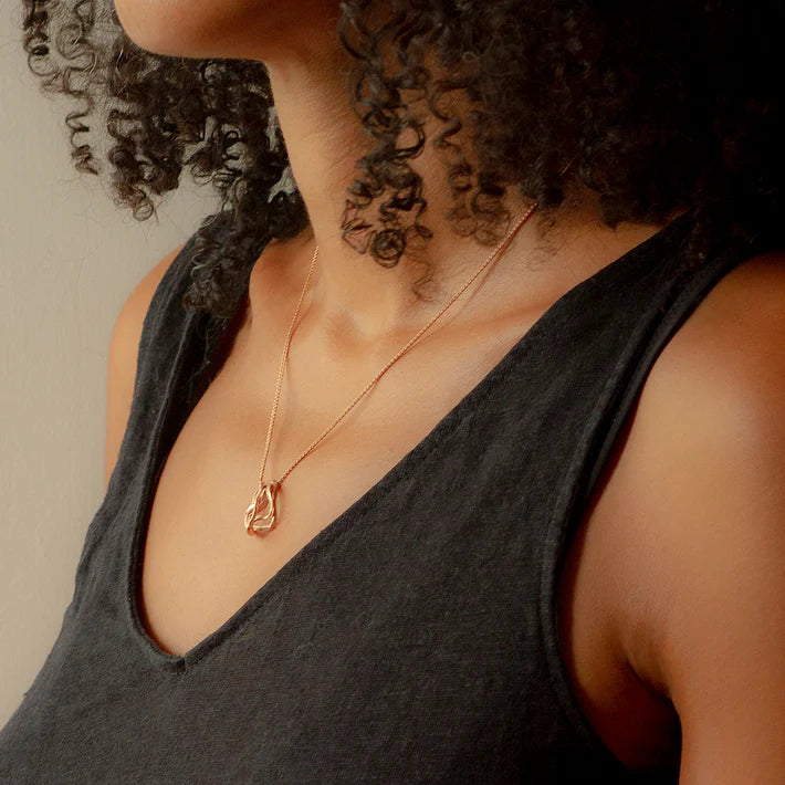gold pebble pendant worn