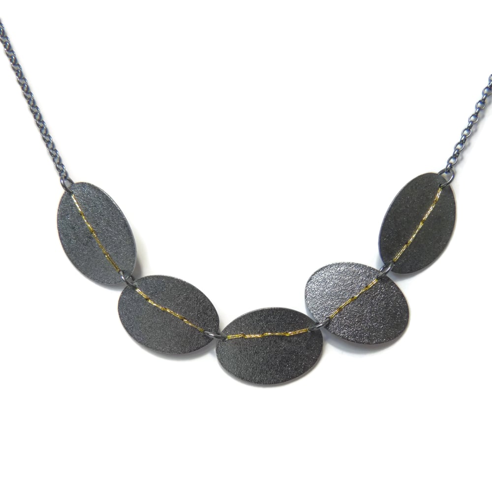 Sewn up 5 disk necklaces - gold thread