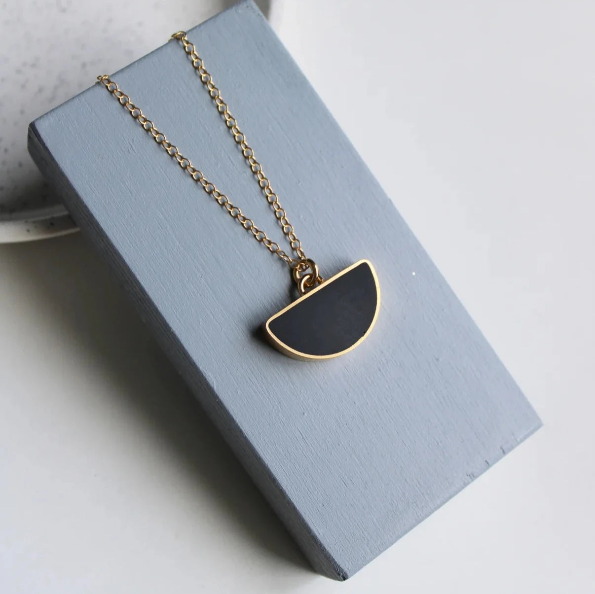 gold arc black pendant