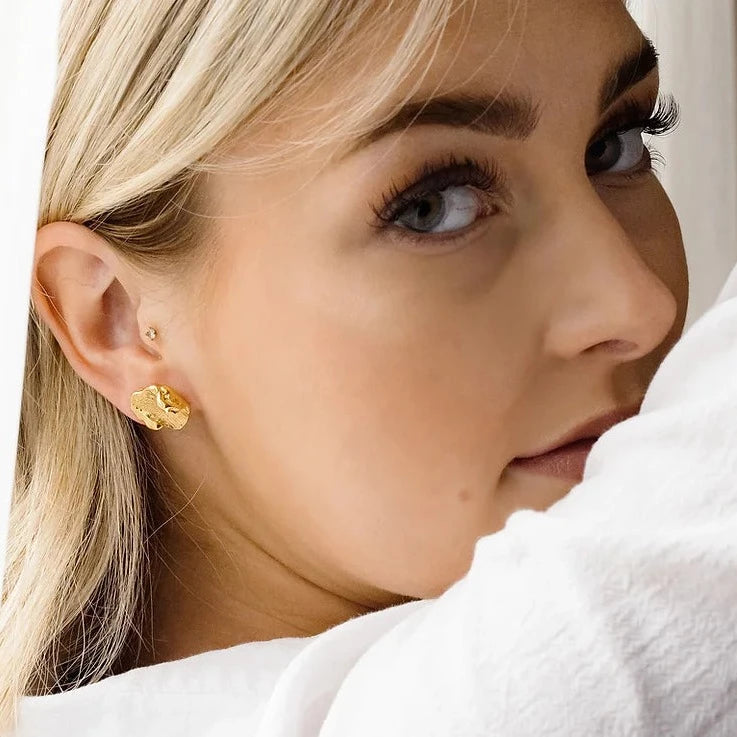 gold smudge earrings worn