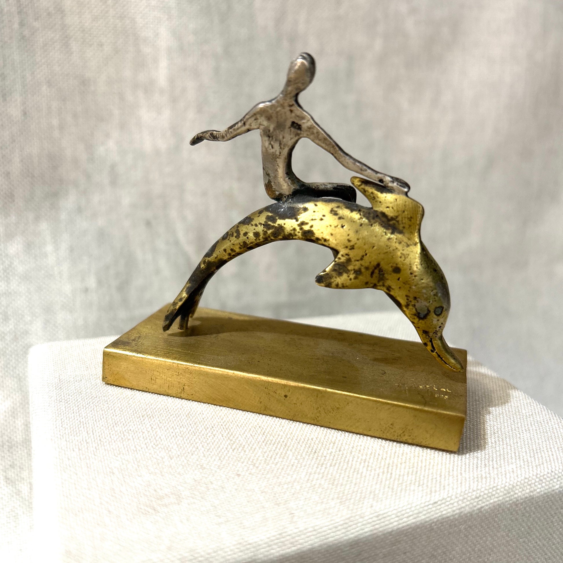 man on dolphin sculpture